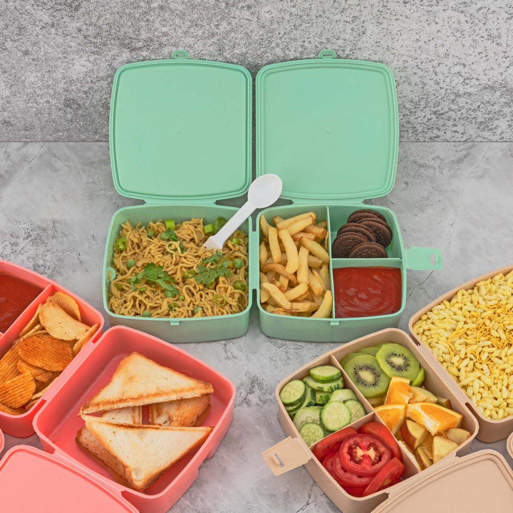 Front view of a blue Double Layer Lunch Box with a spoon and four internal compartments.