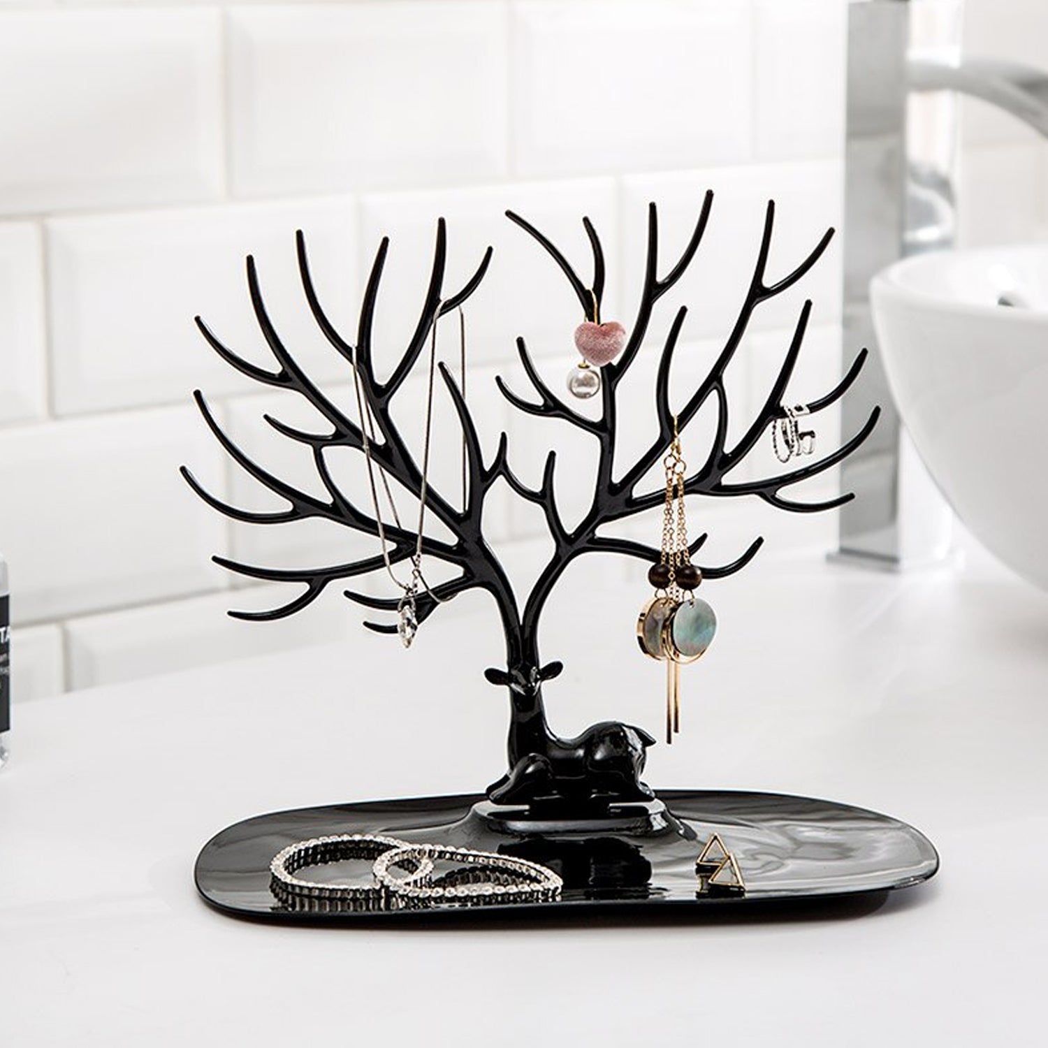 Side view of deer shaped jewellery holder showcasing antler branches and oval tray