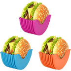 Set of silicone burger holders in various colours on a table.