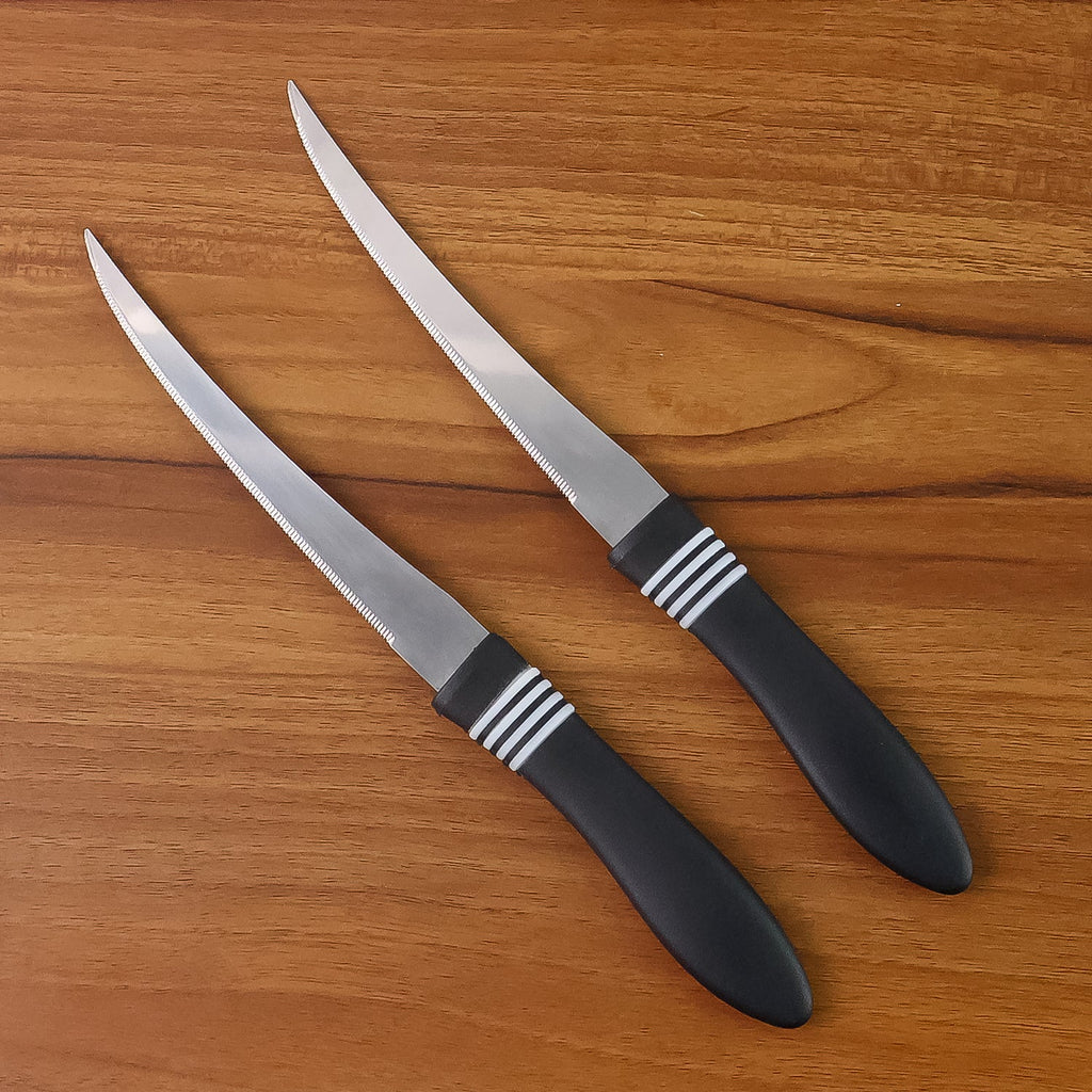 Ergonomic black ABS handle of serrated kitchen knife for comfortable grip