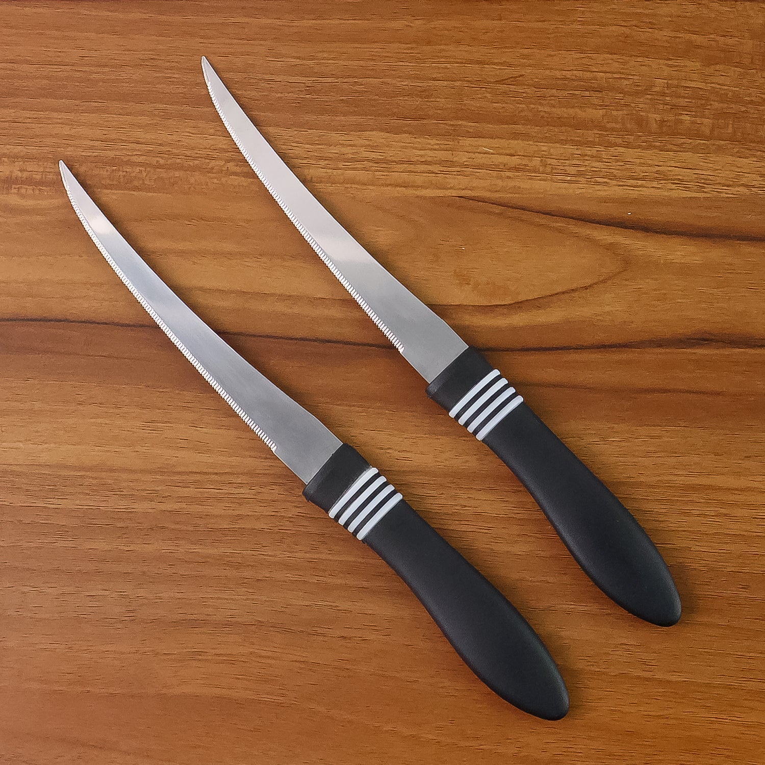 Ergonomic black ABS handle of serrated kitchen knife for comfortable grip