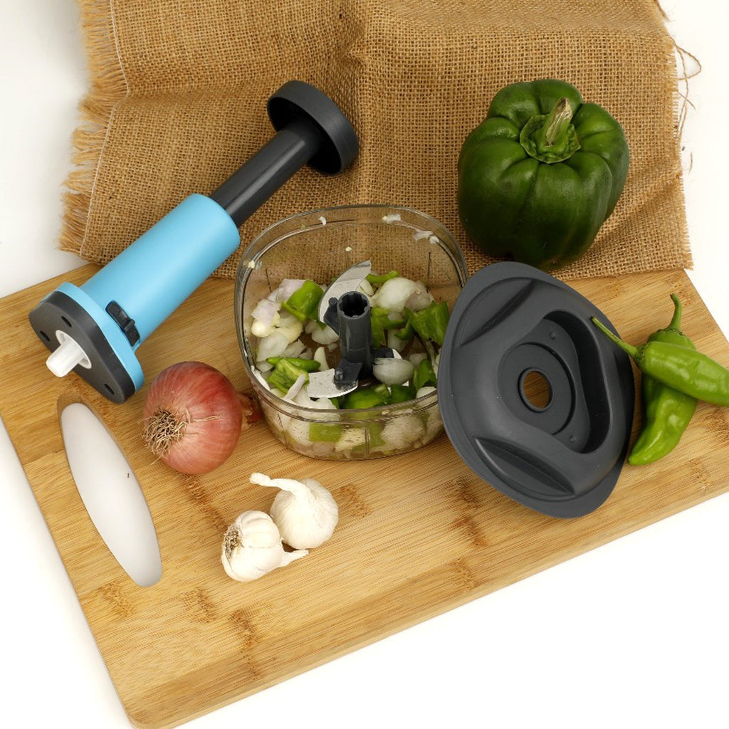 All components of the hand push vegetable cutter, including blades and container, ready for assembly.