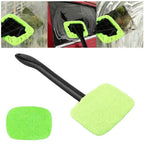 Glass cleaner wiper tool with microfiber cloth in use for car windshield cleaning