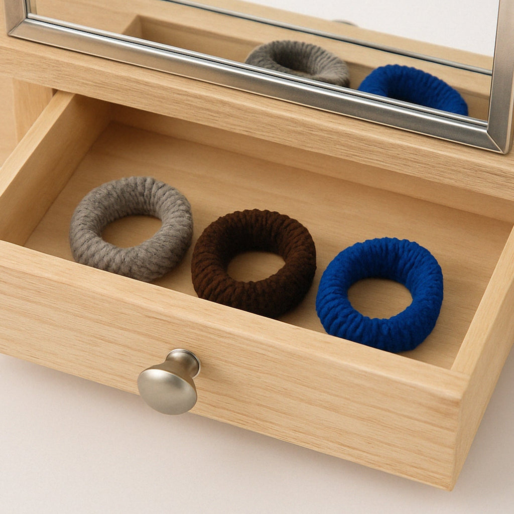 Assortment of colourful tyre shape hair bands on a clean white background.