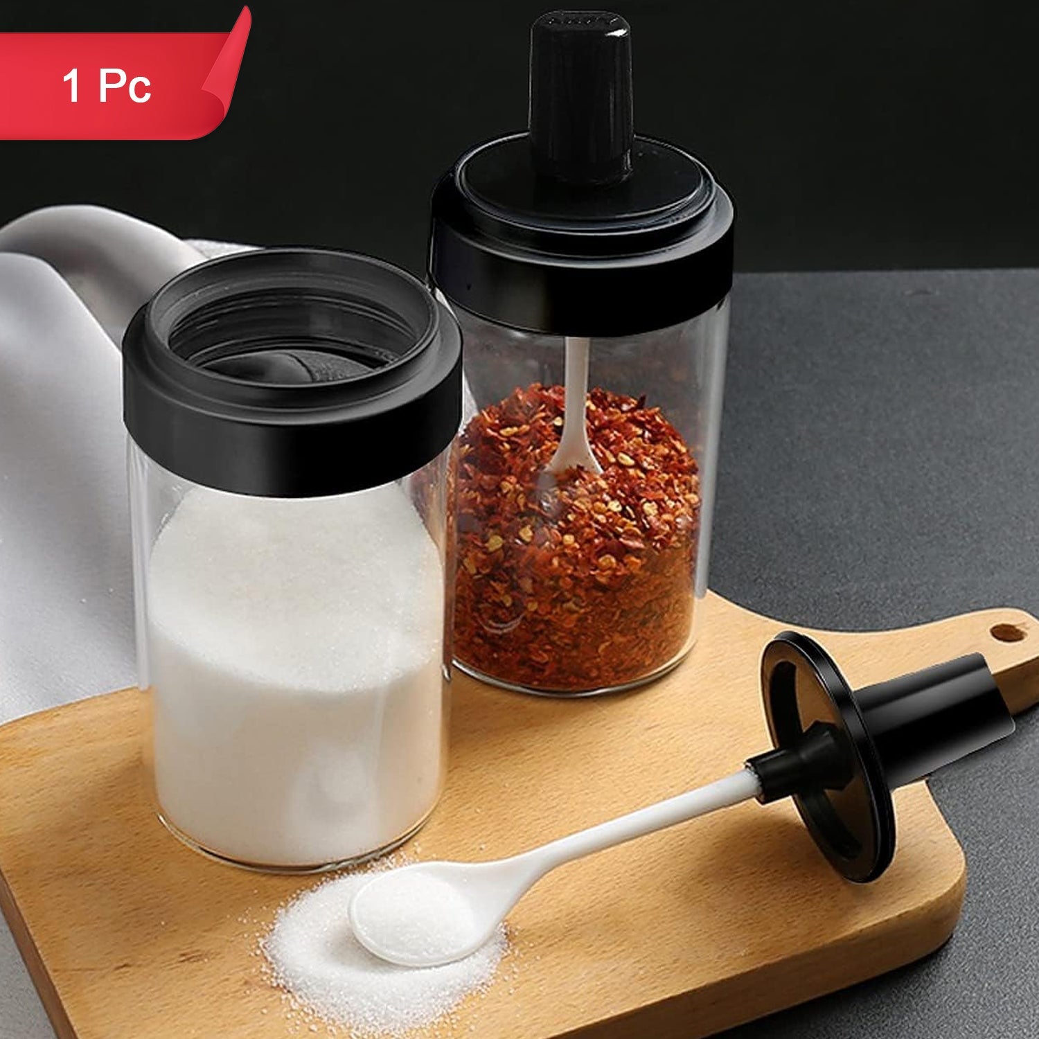 Glass spice jar set with wooden tray for organized multipurpose masala storage.
