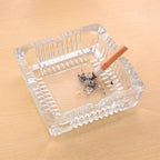 Top-down view of the glass ashtray, showing the four integrated slots for cigarettes.