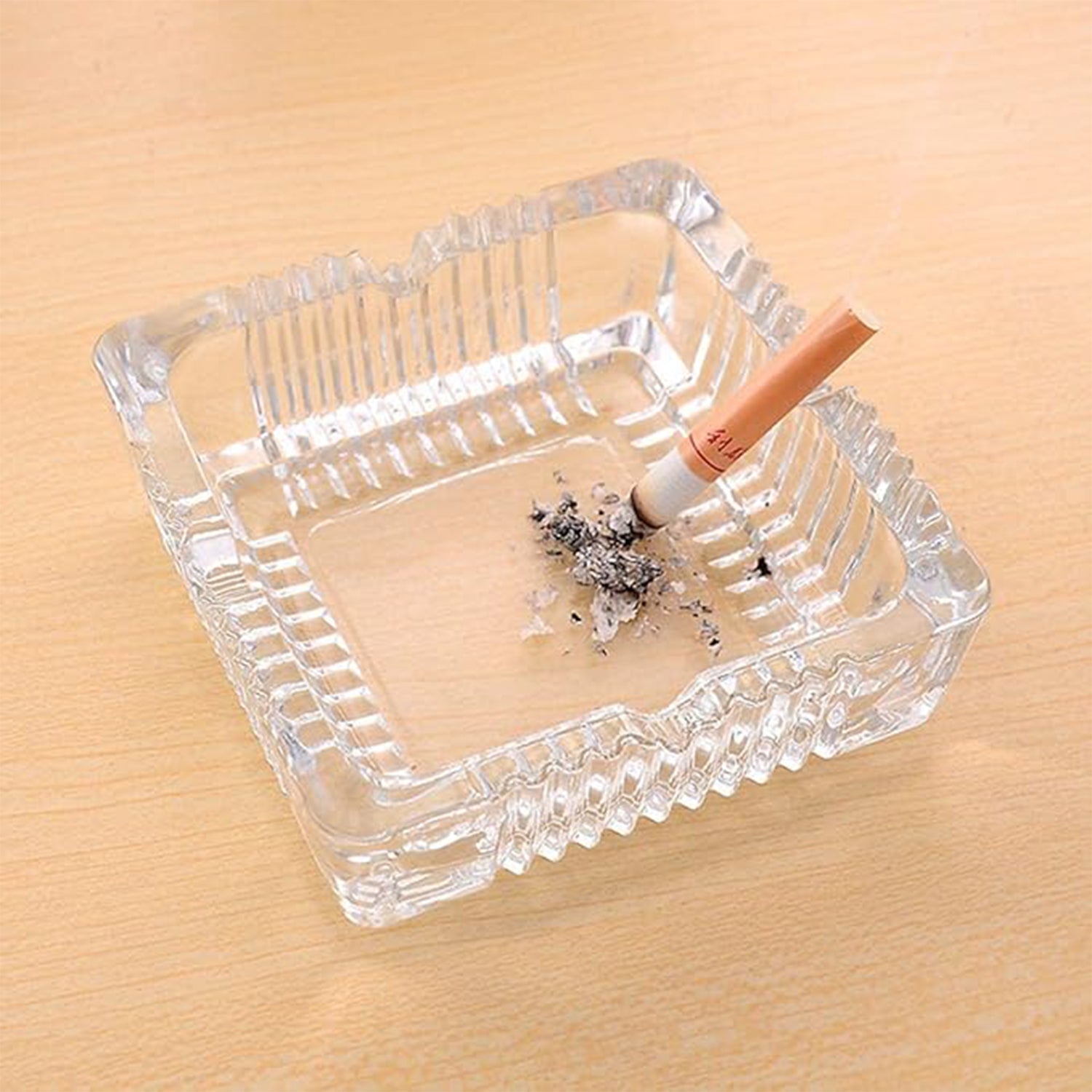 Top-down view of the glass ashtray, showing the four integrated slots for cigarettes.