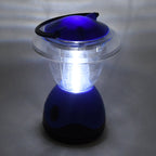 Person holding the compact Indo Glow Mini Camping Lantern, showcasing its portable design.