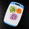 Pro Clean plastic chopping board with non-slip surface for safe vegetable preparation.