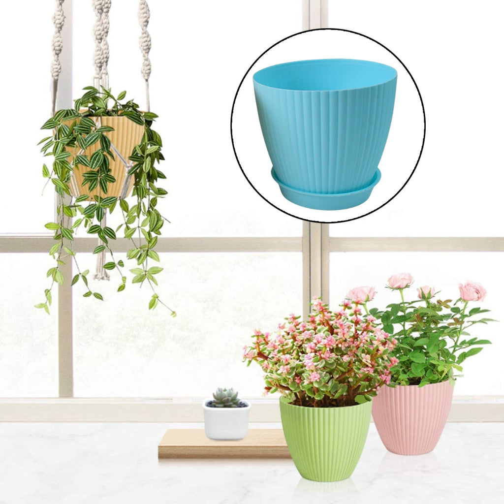 Various plants thriving in the stylish plastic flower pot set, arranged in an indoor setting.