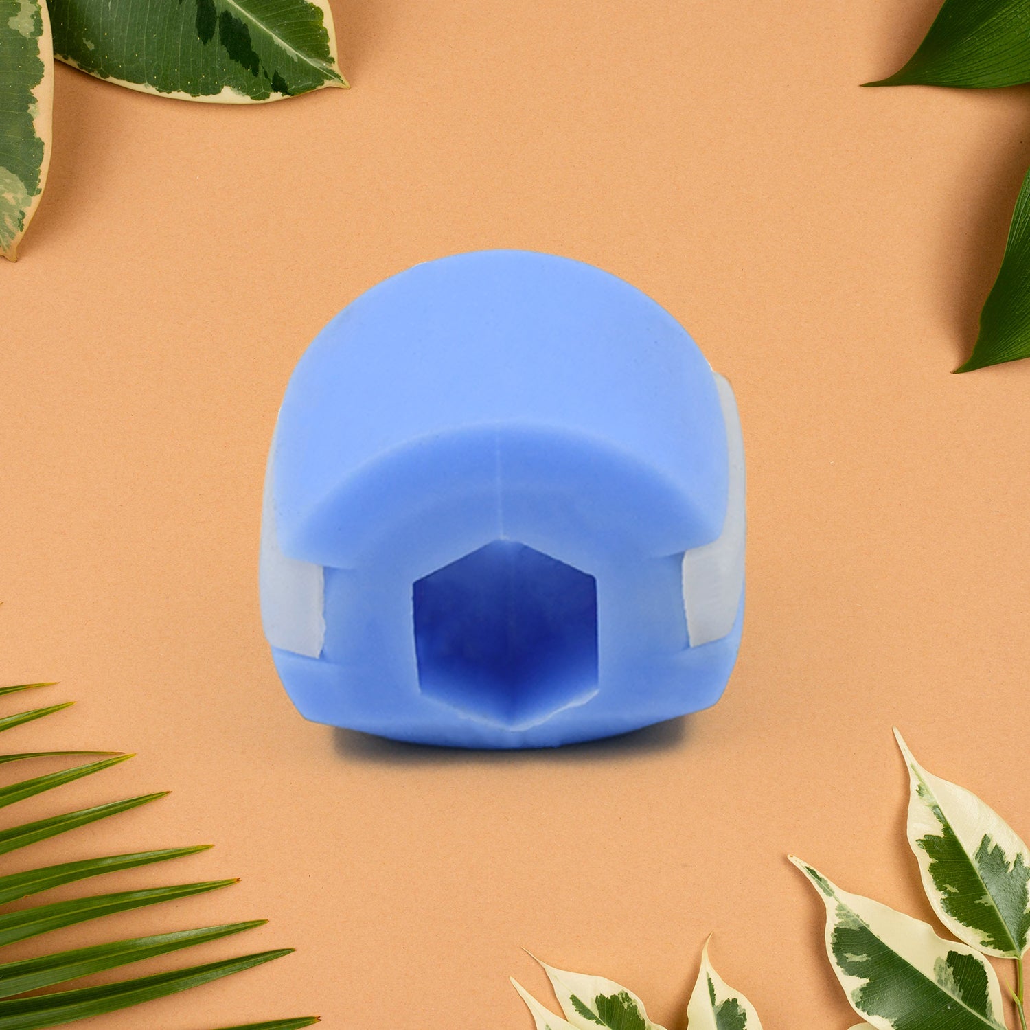 Side profile of the blue jawline exerciser, highlighting its ergonomic shape.