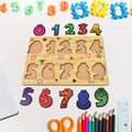 Toddler happily playing with a colorful wooden number puzzle board.