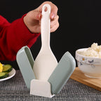 Close-up of automatic lid opening mechanism on rice spoon holder