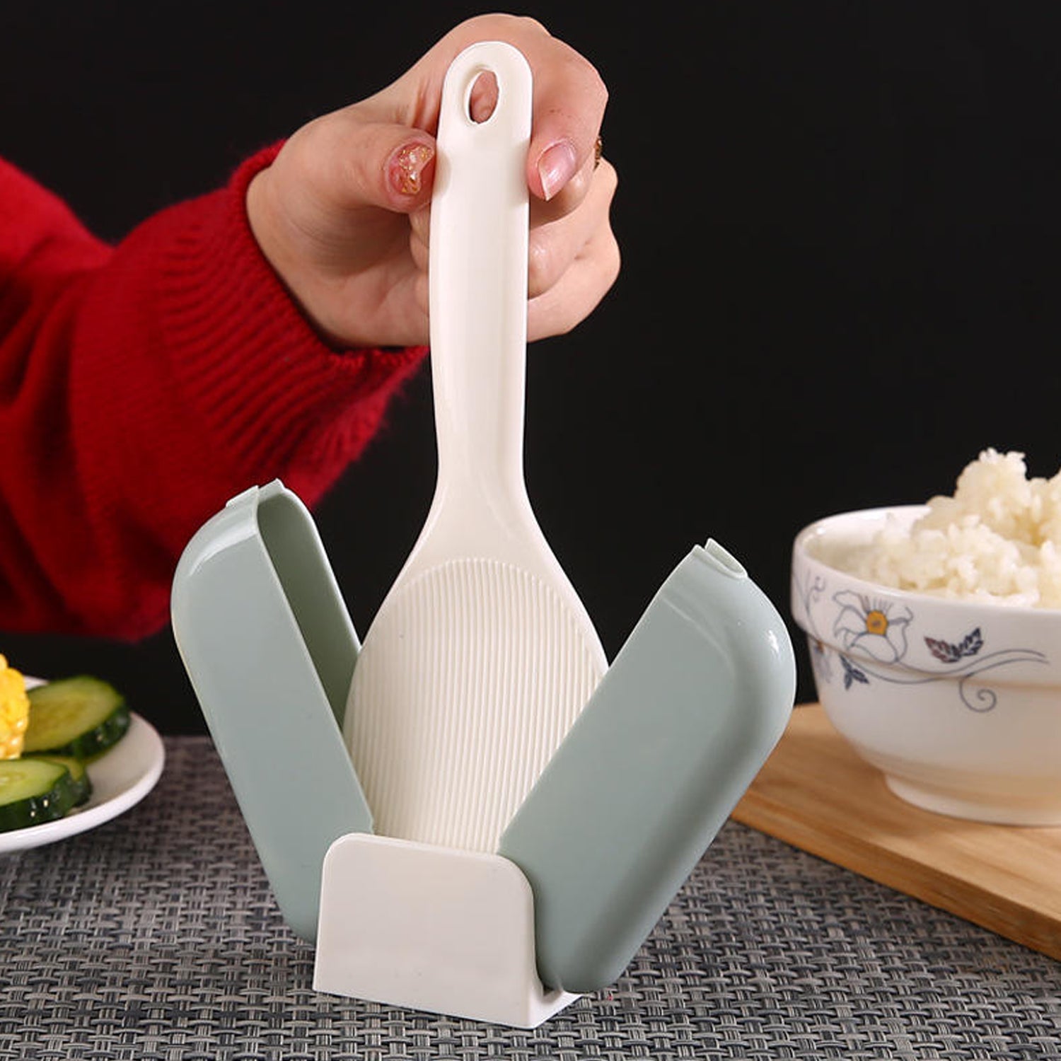 Close-up of automatic lid opening mechanism on rice spoon holder