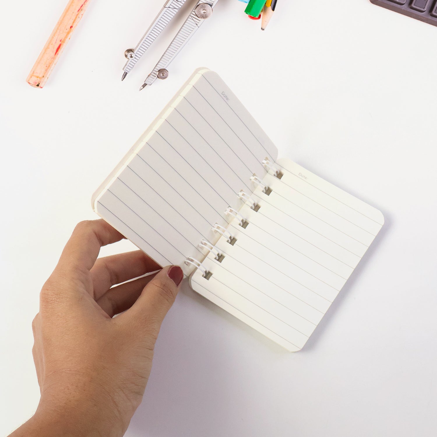 Daily notes being written in a small spiral bound pocket notebook