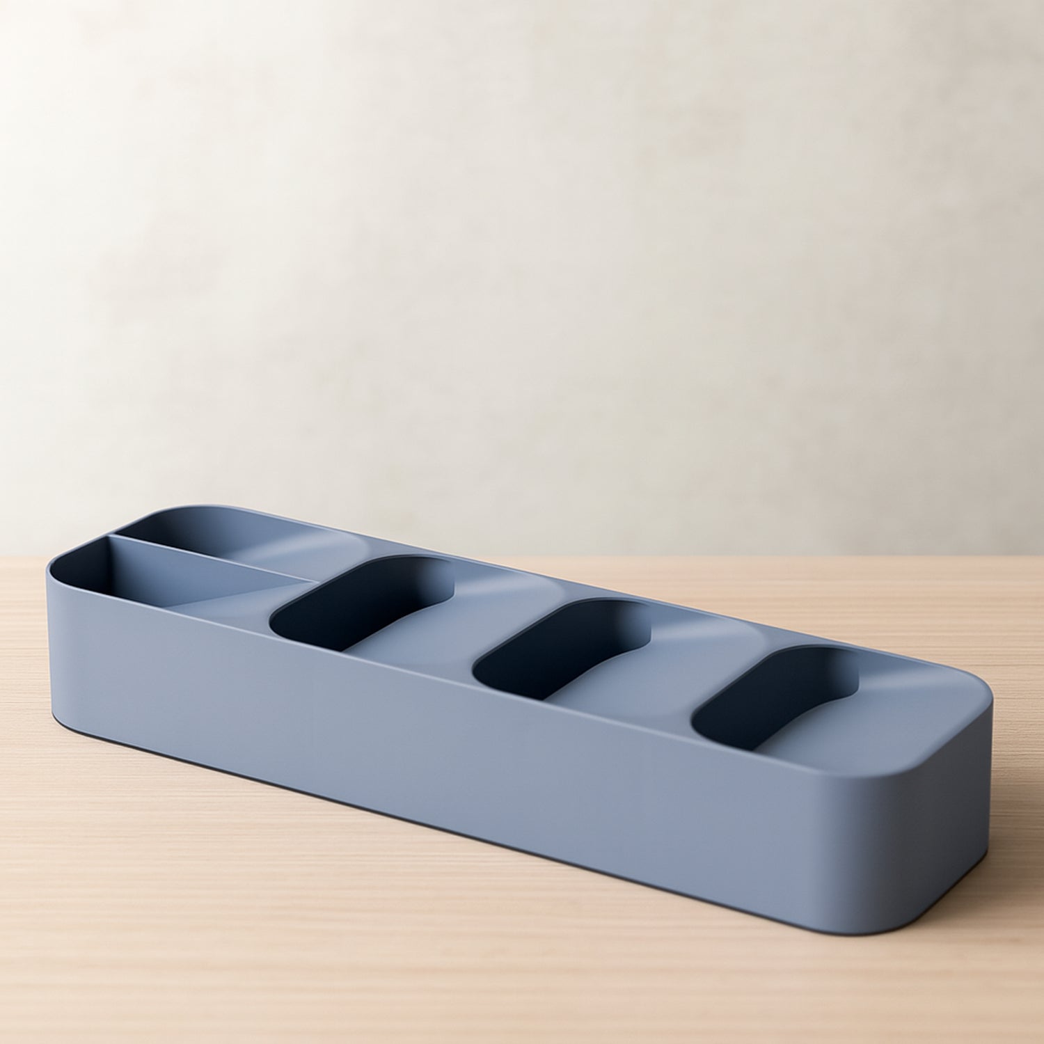 Close-up of the compact cutlery tray holding various utensils, demonstrating its space-saving design.