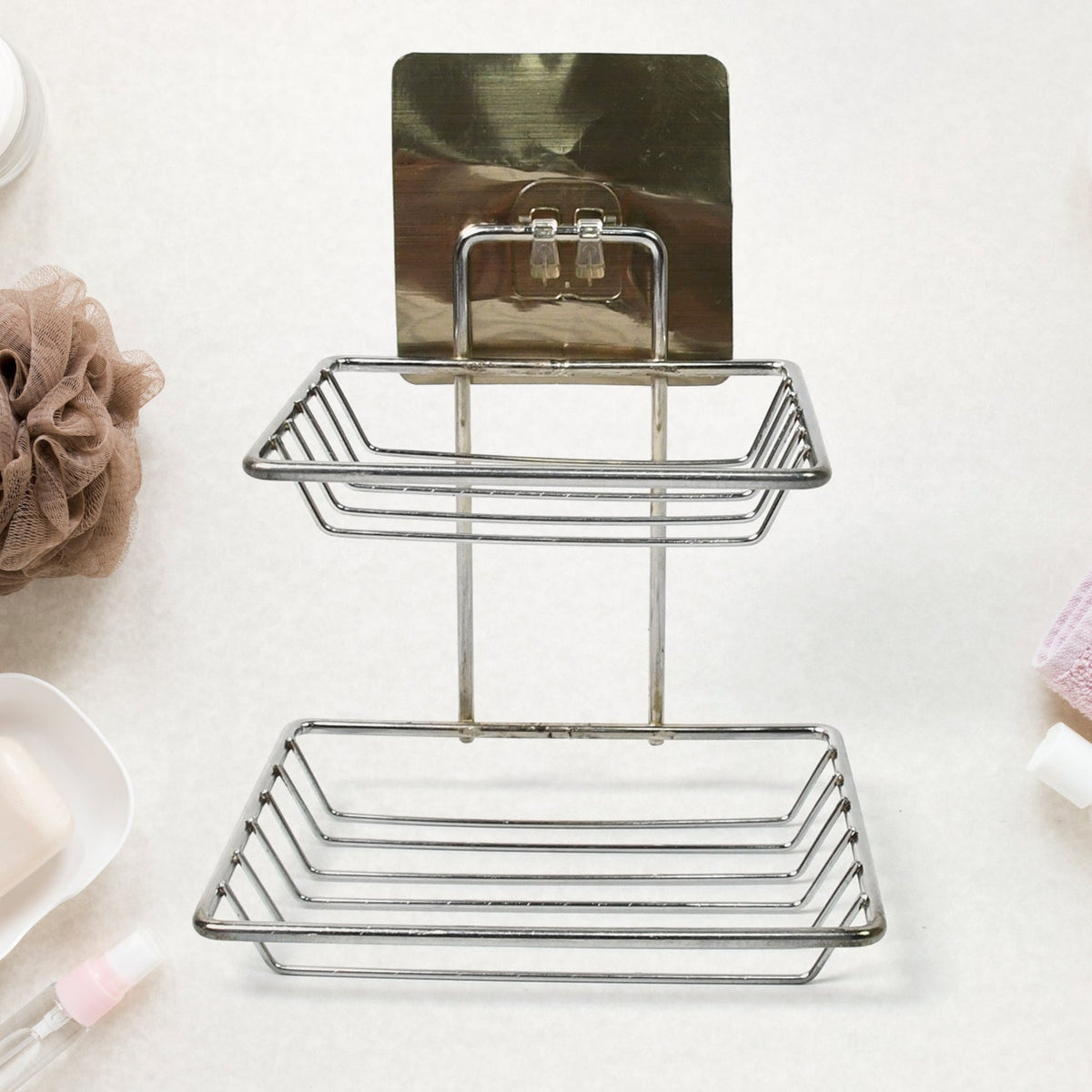 Wall mounted stainless steel soap dish with dual hooks in a modern bathroom.