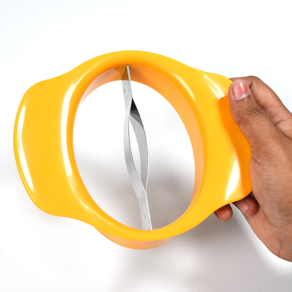 Hand holding the mango slicing tool over a mango, demonstrating its ergonomic design.