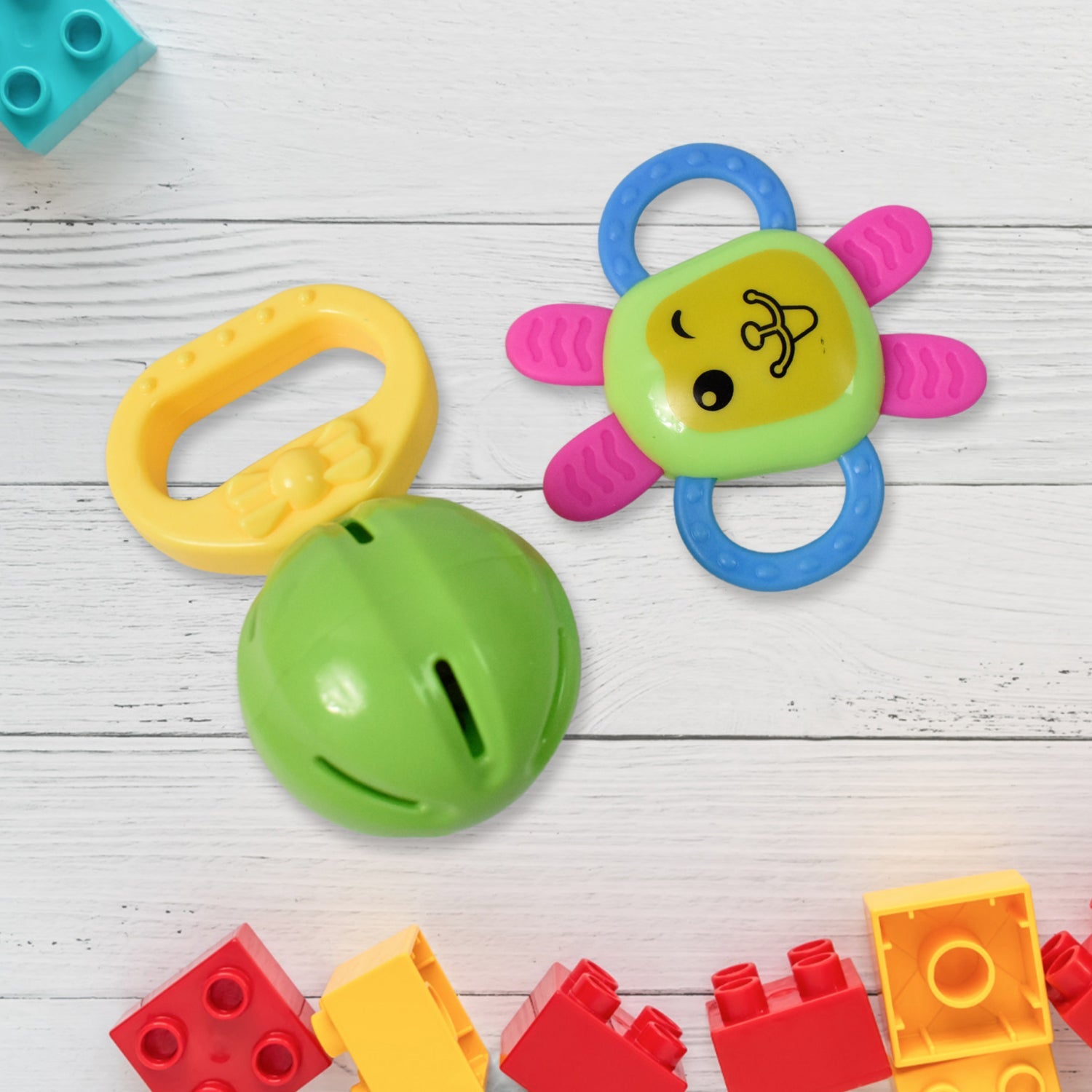 Close-up of baby's hand grasping an ergonomic yellow teether toy