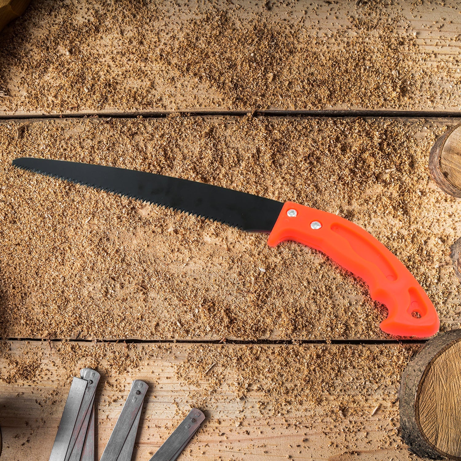 Gardener using the portable hand pruning saw to cut a tree branch cleanly.