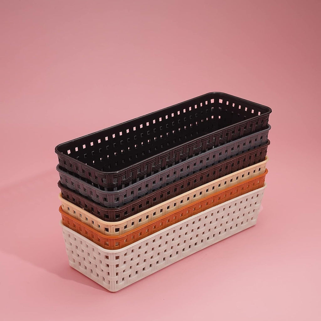 Close-up of a desk organizer tray holding office supplies like pens and clips.