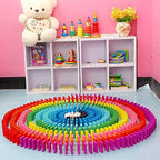 Child happily playing with the 120 Pcs colorful wooden domino blocks set.