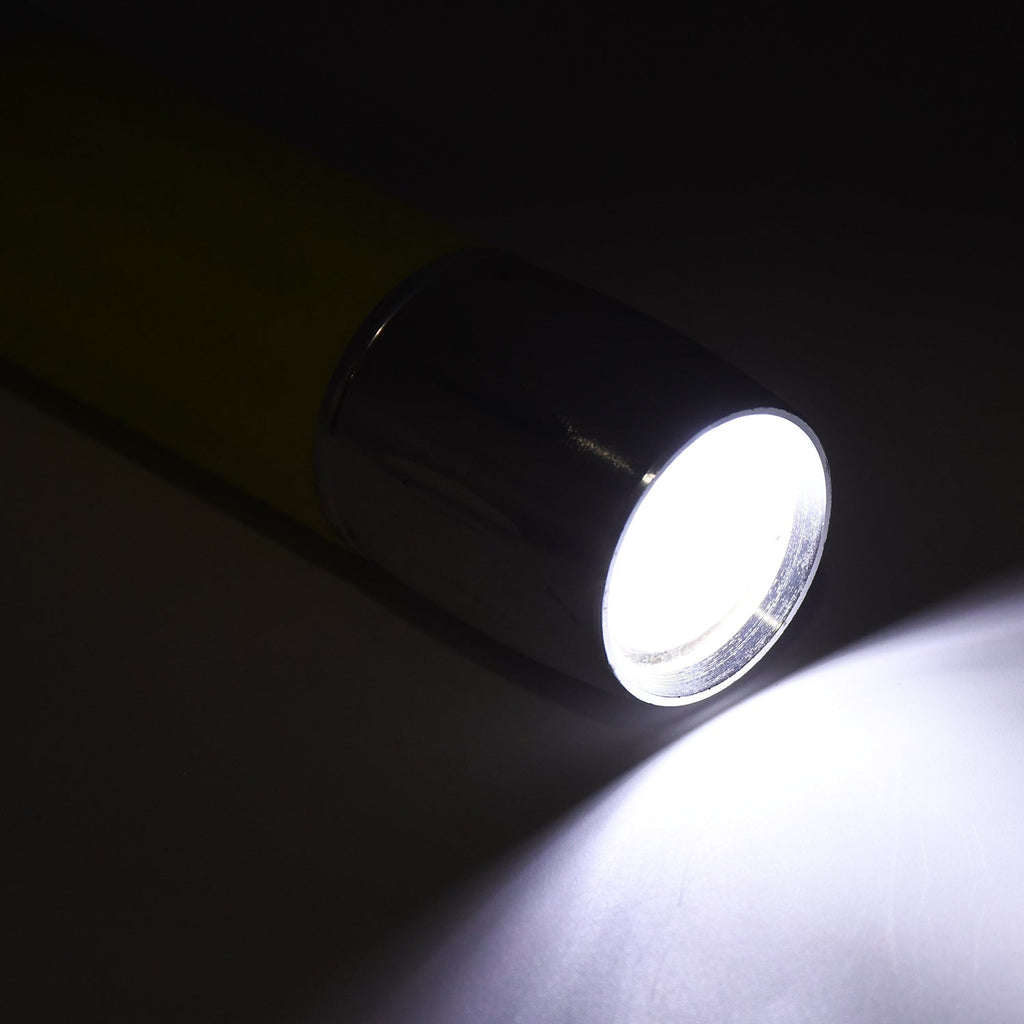 A person using the portable torch to illuminate a dark space, demonstrating its effectiveness.