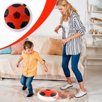 Child playing with soft kick hover soccer ball indoors