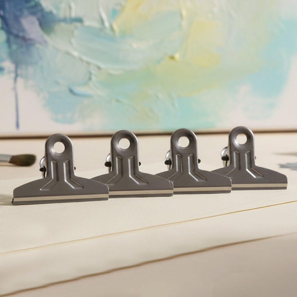 Reusable metal binder clips holding bills and notes securely