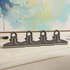 Reusable metal binder clips holding bills and notes securely