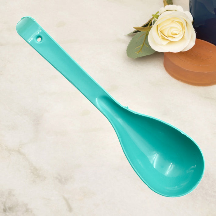A single food-grade plastic serving spoon showcasing its ergonomic handle and practical design.