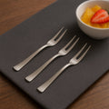 Set of six elegant stainless steel fruit forks with mirror finish