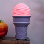 Purple ice cream humidifier emitting mist on table