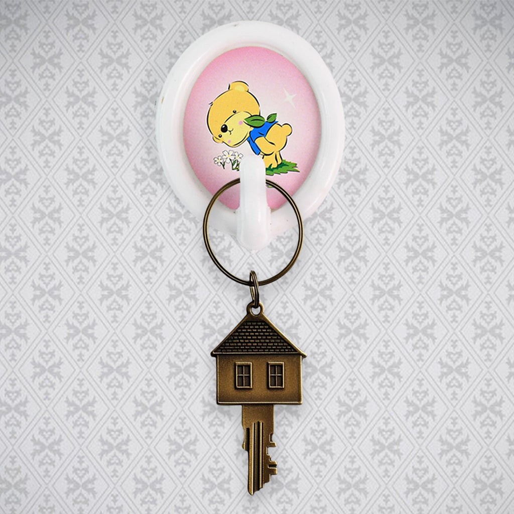 A smiley wall hook holding a kitchen ladle, demonstrating its functionality in a modern kitchen setting.