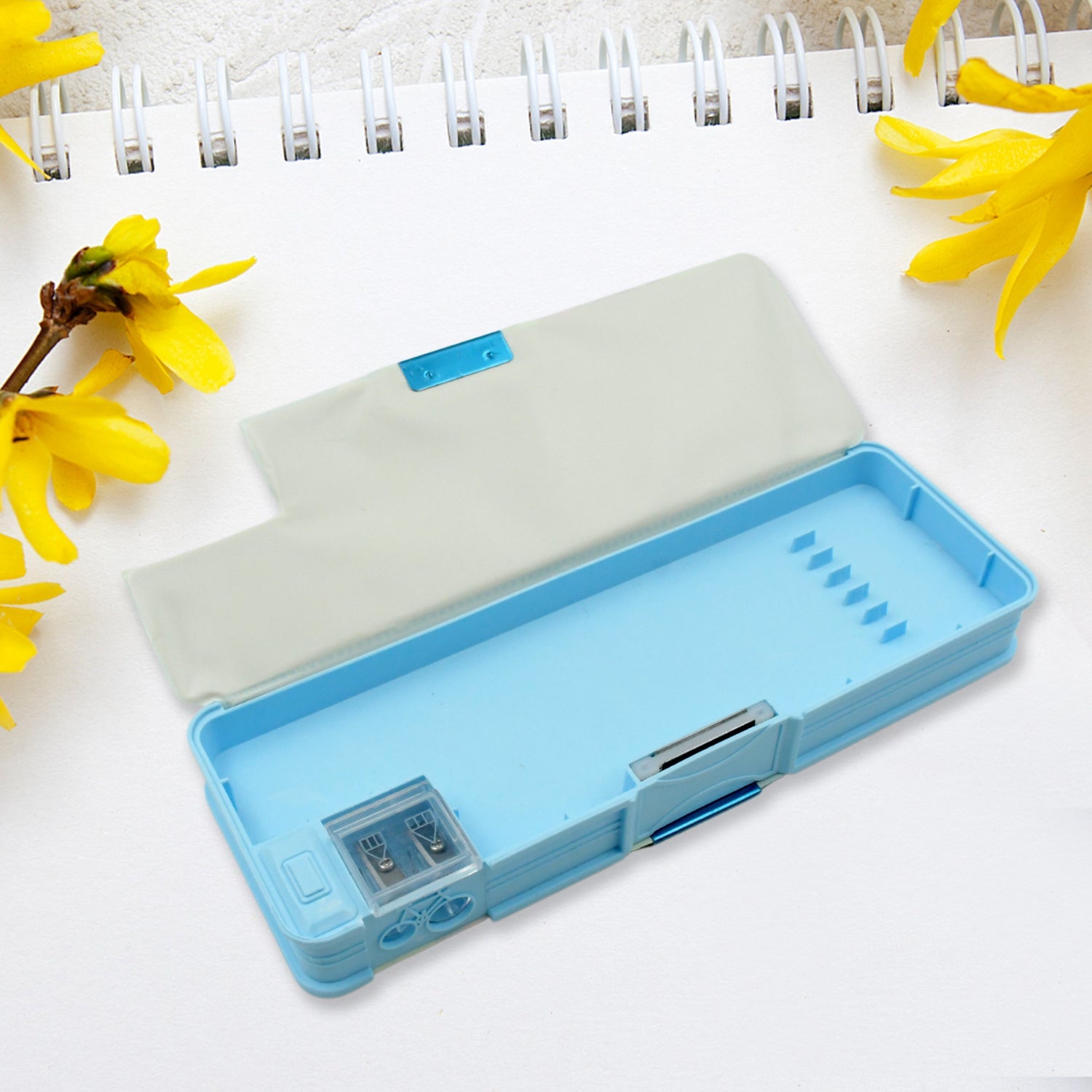 Open plastic pencil box with empty compartments, highlighting its storage capacity.