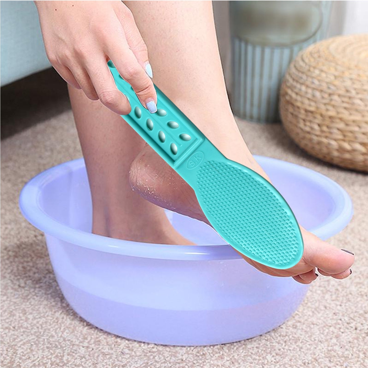 Top-down view of the plastic foot scrubber, showing its full length and handle.