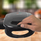 Angled view of the Sandwich Maker, highlighting the power and ready indicator lights.