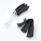The compact blind cleaner brush being used to clean dust from a car's AC vent.