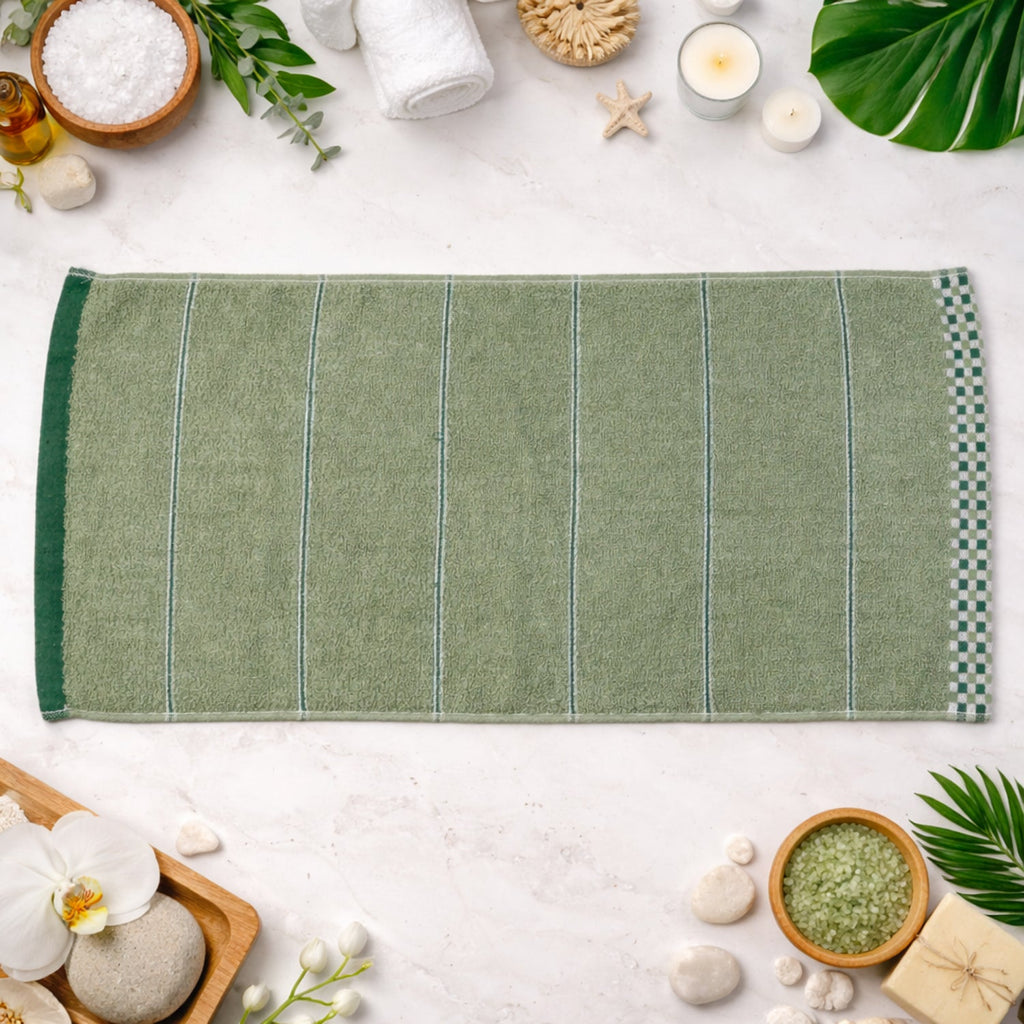 Folded soft cotton bath towel on white background, ideal for home and gym