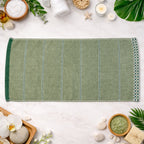 Folded soft cotton bath towel on white background, ideal for home and gym