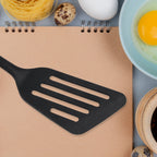 Versatile silicone kitchen turner with an ergonomic handle.