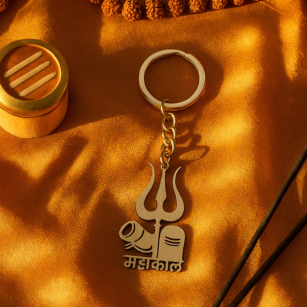 Compact spiritual metal keychain displayed alongside a set of keys for scale.