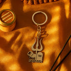 Compact spiritual metal keychain displayed alongside a set of keys for scale.
