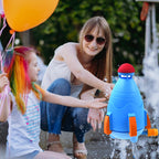 The water rocket sprinkler launching streams of water in a backyard.