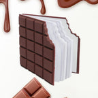 Closed chocolate scented diary with a bite-shape design on a white background.