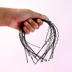 Black metal wavy headband displayed on white background