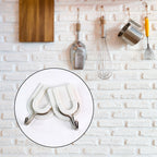 Close-up of a sturdy adhesive wall hook applied to a smooth ceramic tile surface.