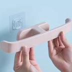 Close-up of the durable PP material self-adhesive towel rack holding neatly folded bath towels.