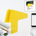 Gambit Mobile Charging Stand securely holding a smartphone while plugged into a wall socket.