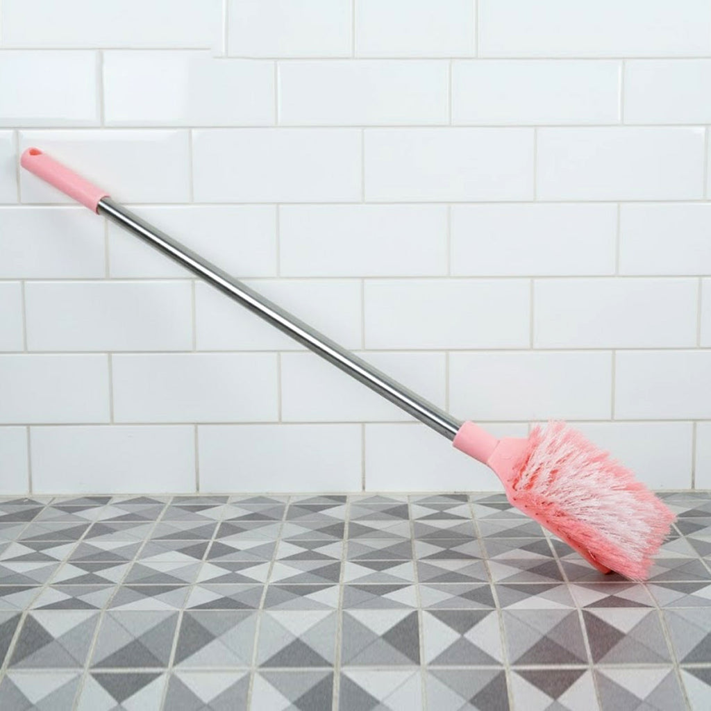 Angled shot of long handle toilet cleaning brush designed for bathroom use